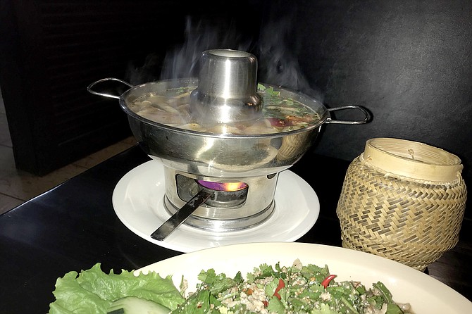 Larb looks on; tom yum cooks on; sticky rice waits.