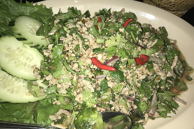 Larb, the Lao national dish - salad, marinated pork, searing hot peppers.