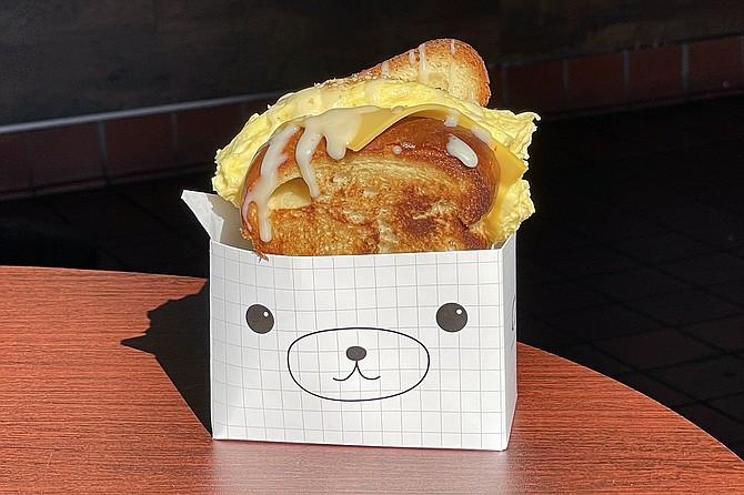 A fluffy rolled omelet and spam breakfast sandwich, in a teddy bear package