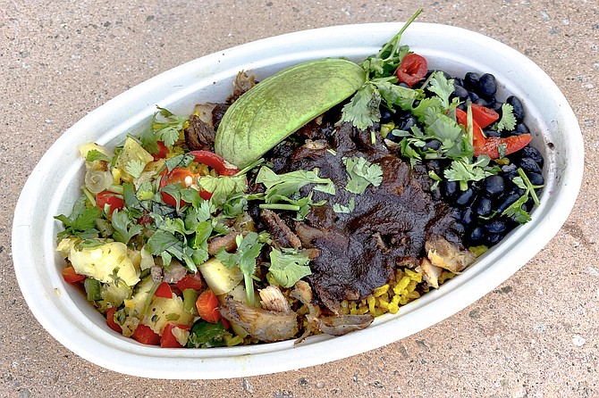 Jerk chicken bowl, with pickled fresno chilis, pineapple salsa, and black beans over turmeric brown rice