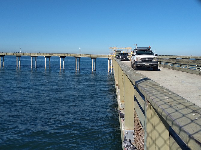 The divers are standing by, eager to dive in and start repairs on two damaged pilings.