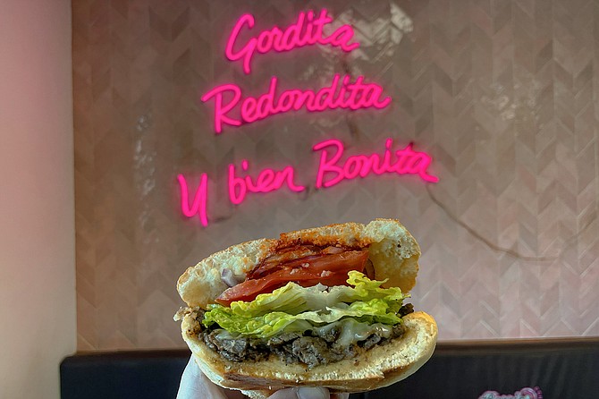 The neon sign refers to donuts, but the shop also serves tortas and tamales.