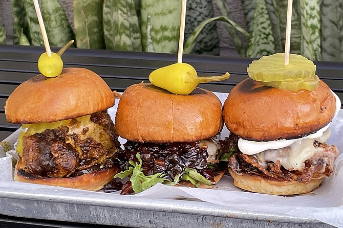 A trio of sliders: (from left) curry fried chicken, bacon whiskey with arugula burger, and Maui onion with kewpie burger