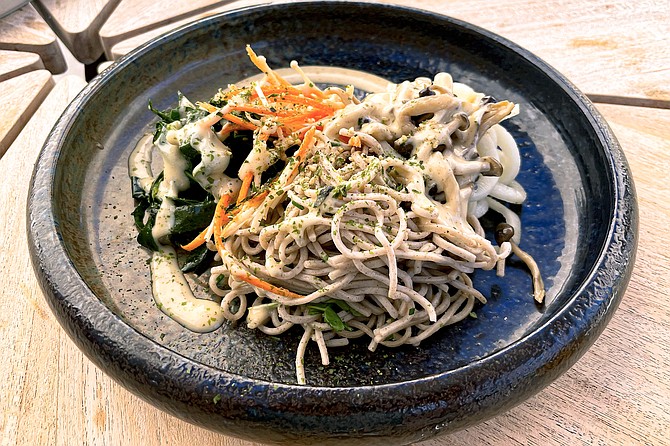Buckwheat noodles, served over sesame collard greens with pickled kohlrabi "noodles"