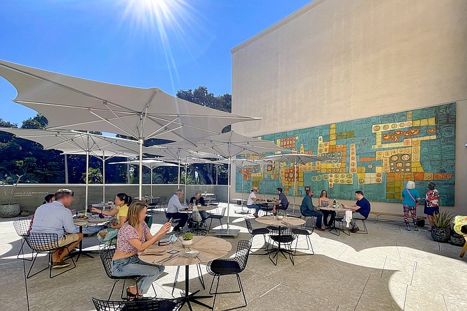 The Artifact dining patio, now home to the San Diego produced enamel and metal artwork, “Variations on a Gold Theme."