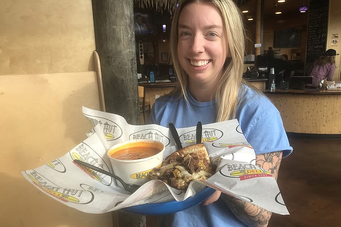 Kayleigh brings my tomato soup and Cali Cheese Steak.