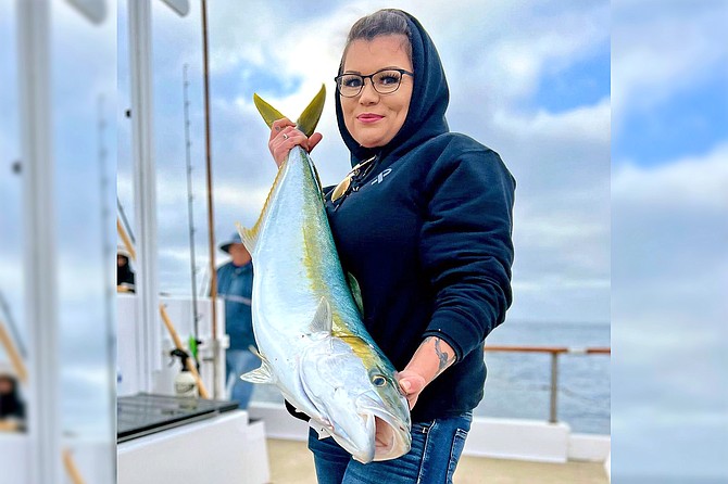 Happy angler with a nice yellowtail landed in tough conditions off the Baja Coast while aboard a full day trip aboard the San Diego out of Seaforth Sportfishing.