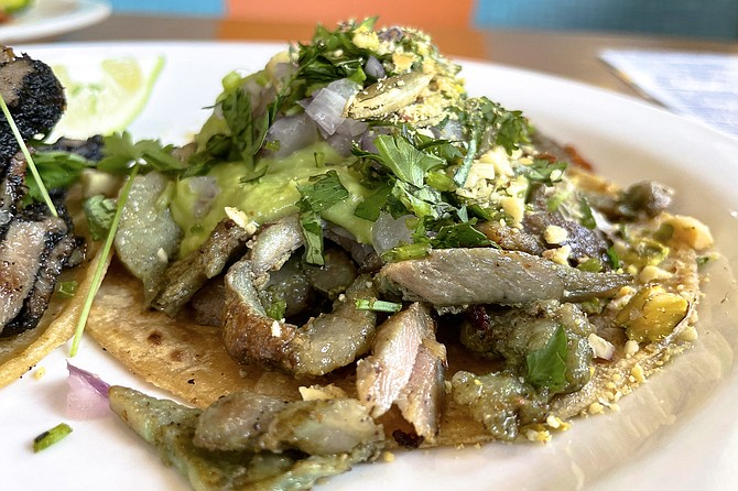 An al pastor verde taco, seasoned in part with ground nuts
