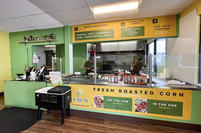 A service counter explaining the street corn options