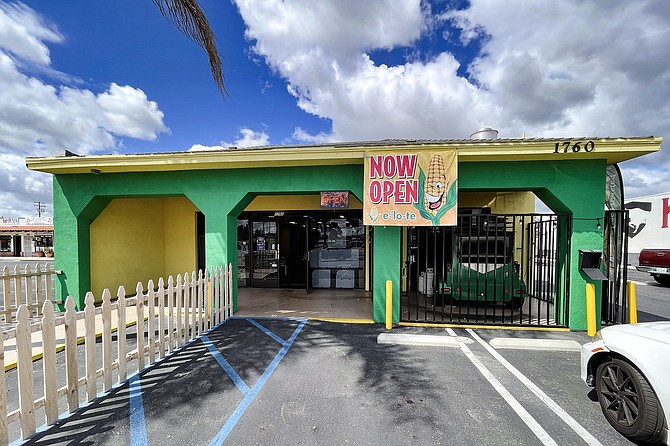 A taco shop in Escondido, with a mobile corn roaster visible within the front (right) patio