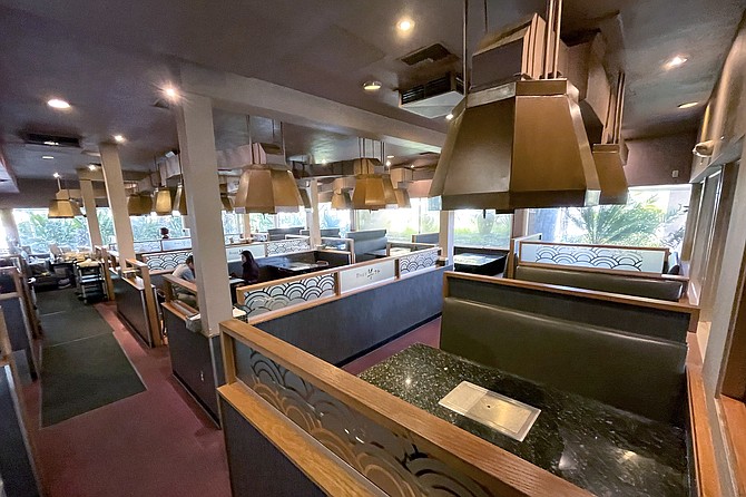 The dining room of Buga Korean BBQ, where each table has its own gas grill