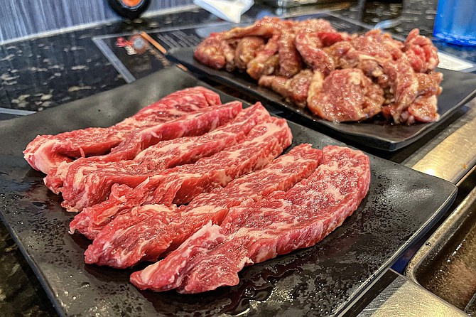 Short rib two ways: a limited portion of filets in front, a large plate of marinated pieces in back