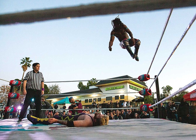 A three-hour “high-flying madness” wrestling show at Dr. Greenthumb’s, with a side of comedy skits, complimentary agua frescas for any incidental cottonmouth, and tacos to sate the fans’ munchies. In this photo: Ju Dizz and Darren Troy Fable “DTF” Down to Fight.