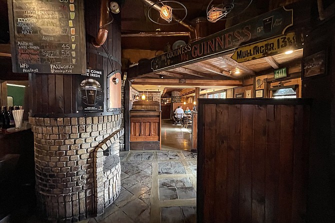 Dark wood booths and stone fireplaces fill out the Hooley's interior; outdoor patio seating is also available.