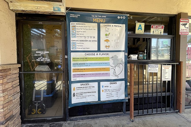 A small ordering window, and menu explaining the assorted pad thai styles and toppings