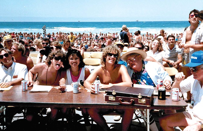 Suns out, tongues out? Author Thomas K. Arnold (fourth from left) judging the 1986 Miss Mission Beach bikini contest with 91X's Rob Tonkin (second from left) and consultant Joel Stevens (seated, right, with hat).