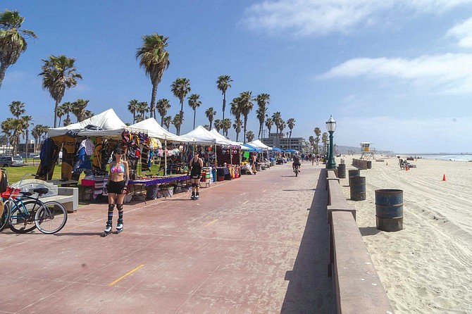 The stretch of boardwalk between the lifeguard station and San Fernando Place has become an open air flea market. “They are ruining the community – they shouldn’t allow them out there,” says Ray Hamel.