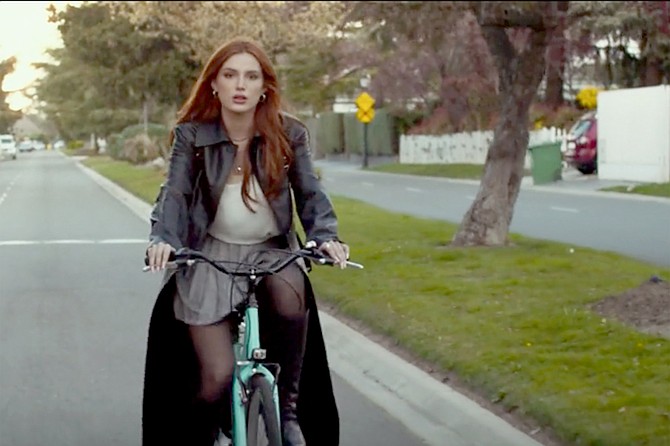 Time is Up: Bella Thorne on a bicycle built for short skirts and handbrake-gnawing lunch hooks.