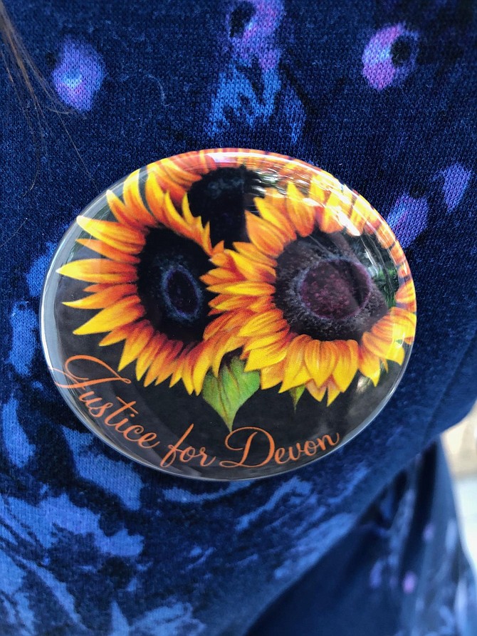 Many supporters of the murdered woman wore buttons that said Justice for Devon. Photo by Eva Knott.