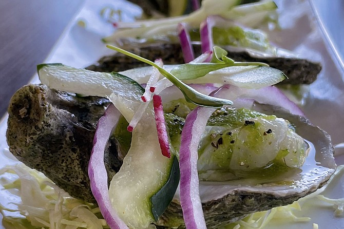 An oyster "stuffed" with green shrimp aguachile