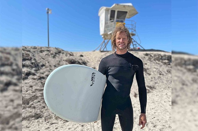 Joe Doering (33) surfs the Ocean Beach Jetty