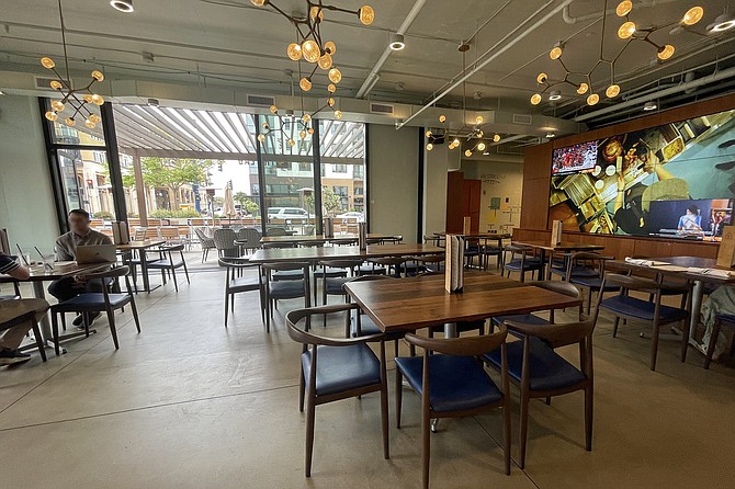 The interior of Lab Collective, including a video wall with promotional video on loop