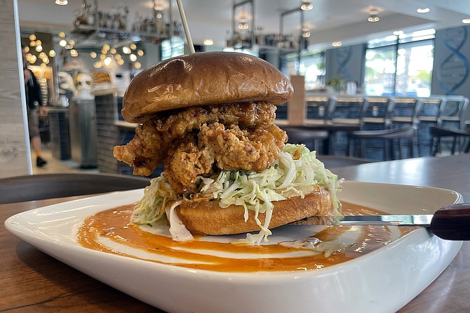 A fried chicken sandwich with bourbon and habanero sauce