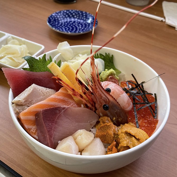 The chirashi bowl, including a shrimp head with eyes and swimmerets