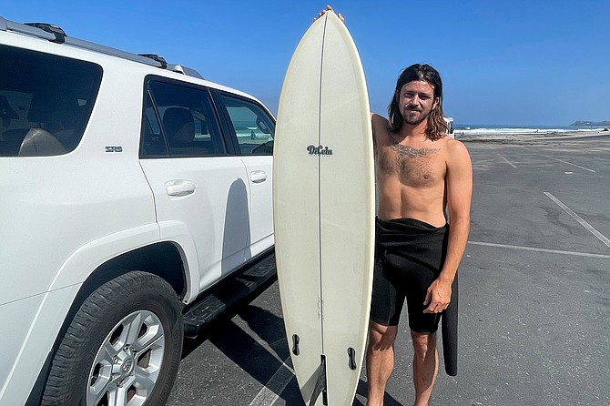 Danny Dicola (37) surfs Solana Beach