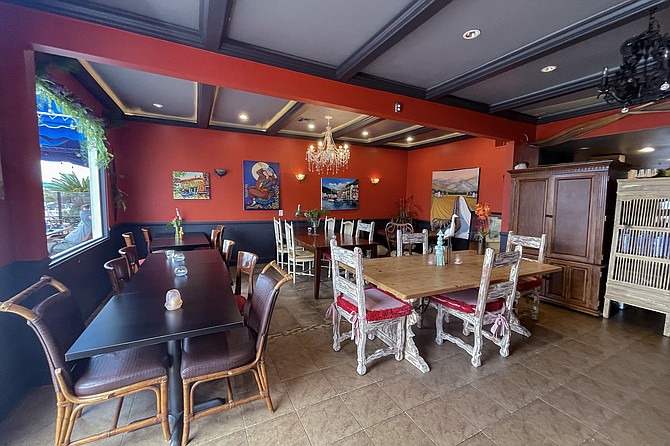 Eclectic furniture, artwork, and chandeliers make for memorable indoor seating.