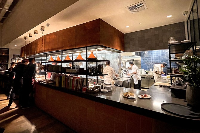Chefs cook within an open kitchen
