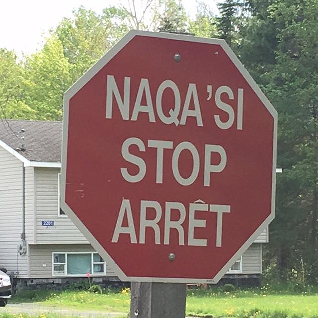Stop sign at Metepenagiag reserve in Mi'kmaq, French and English