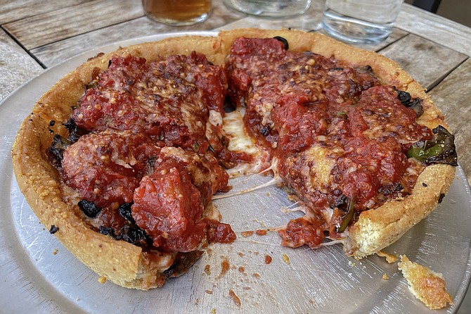A personal "west coast deep-dish" pizza, made with cheese on the bottom and thick, chunky sauce on top