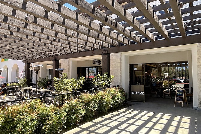 The Shop operates within an upscale suburban shopping center.