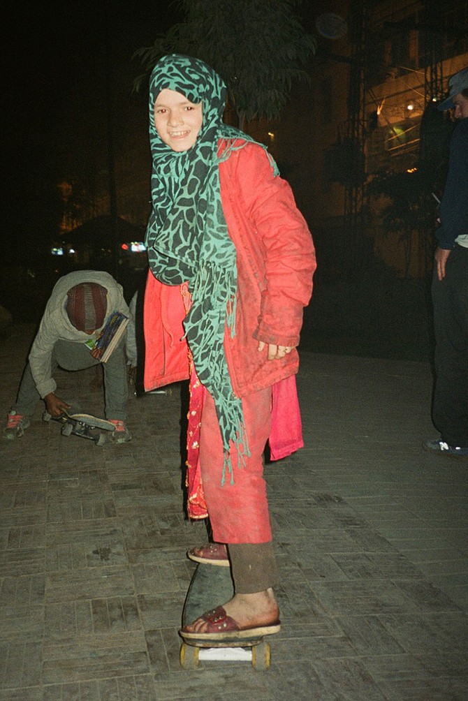 Young Pakistani girl on her first skateboard ride.