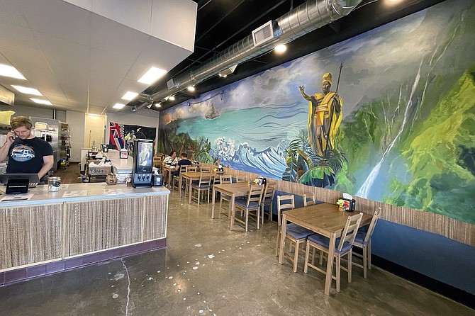 A mural depicts a Hawiian king surveying his lands and seas.