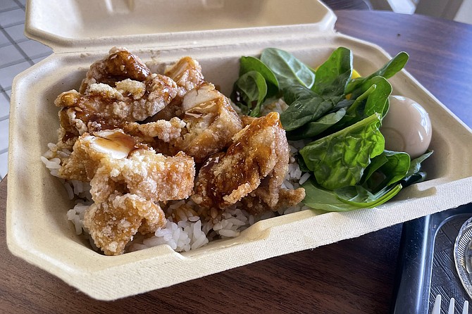 Karaage Don, chopped fried chicken thigh served with rice, egg, spinach, and pickled radish