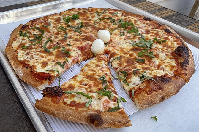 A winning pepperoni and basil pizza, with the 'roni buried under the cheese