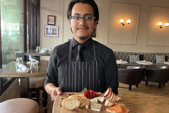 Waiter Roger brings the cheese platter.