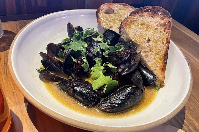 Photo: Steamed mussels in Thai-style tom kha broth | San Diego Reader