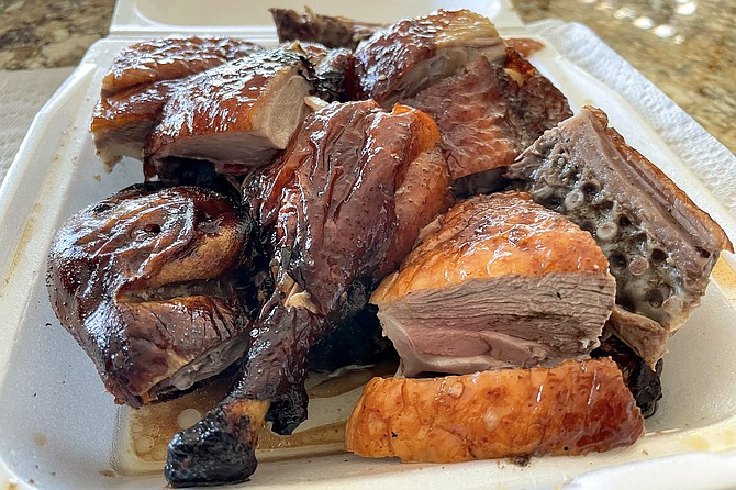 Half a roasted duck, chopped into pieces with a large cleaver