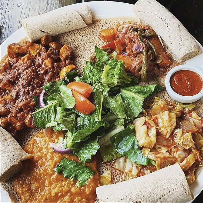 A plate of stews served atop injera, from the Instagram account of Muzita Abyssinian Bistro