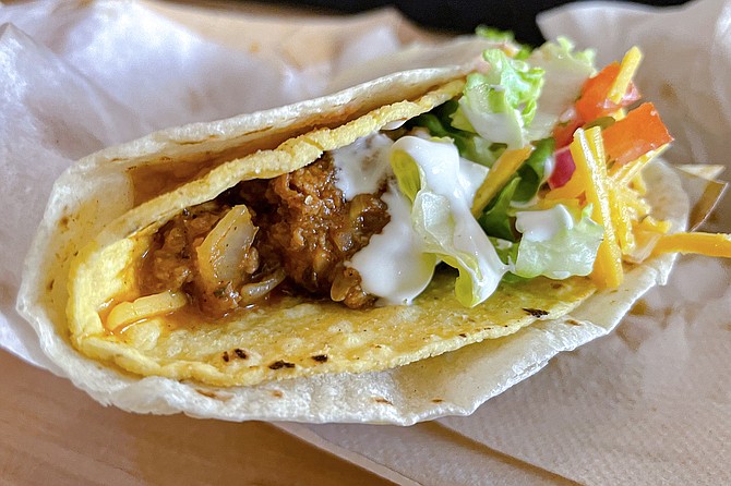 Like a Taco Bell Double Decker, Tacotarian's "super taco" wraps a gringo taco with refried beans and a flour tortilla