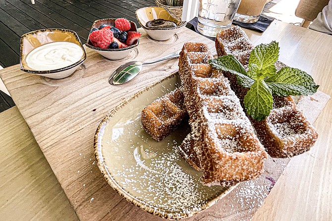 Waffle churro sticks, served with maple cream cheese and blackberry jalapeño sauces