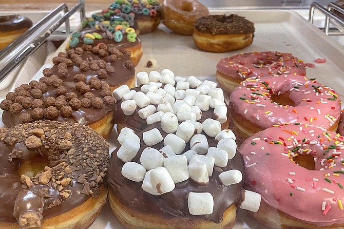 A whole bunch of donut toppings available