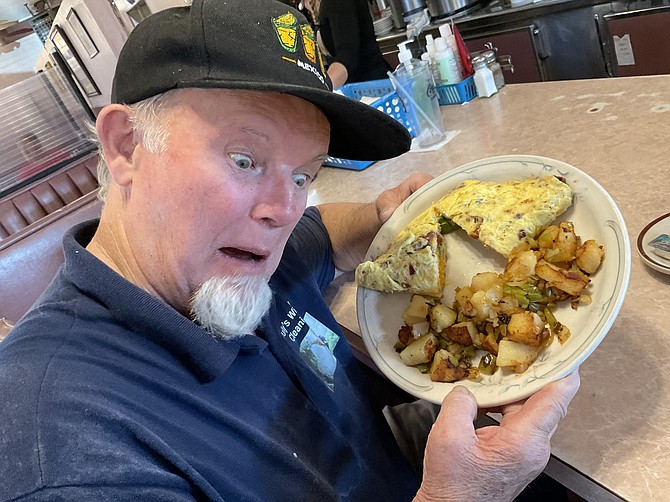 My buddy Tim mugs a freakout at his ABC omelet. But he ate the whole thing.