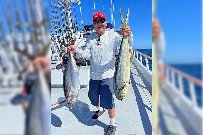 Another happy angler with a dorado and a tuna caught while fishing aboard the Dolphin.