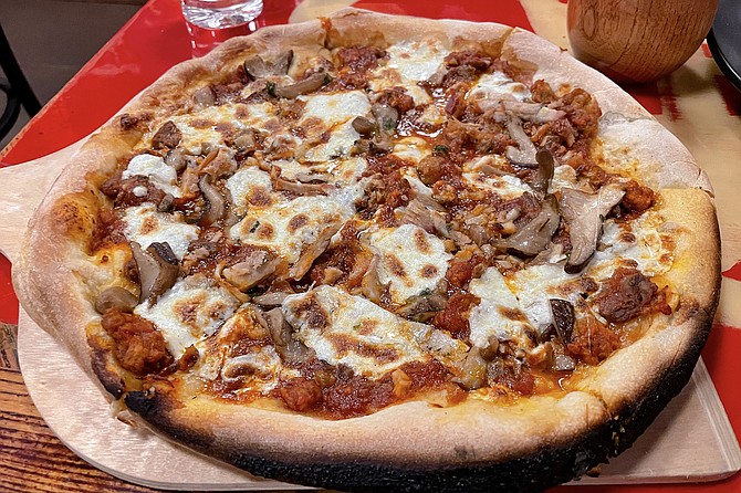 Wood-fired pizza made with miso-marinara, topped by Italian sausage, chashu pork, shaved beef, and shiitake mushrooms