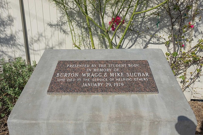 A plaque in memory of principal Burton Wragg and custodian Mike Suchar stands at the former school site.