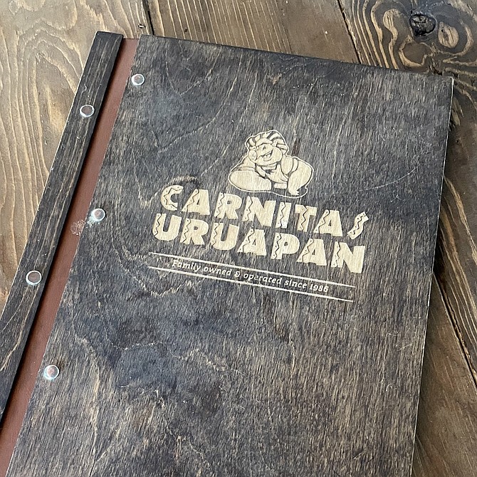 A hard-cover menu, rather than wall-mounted menu board